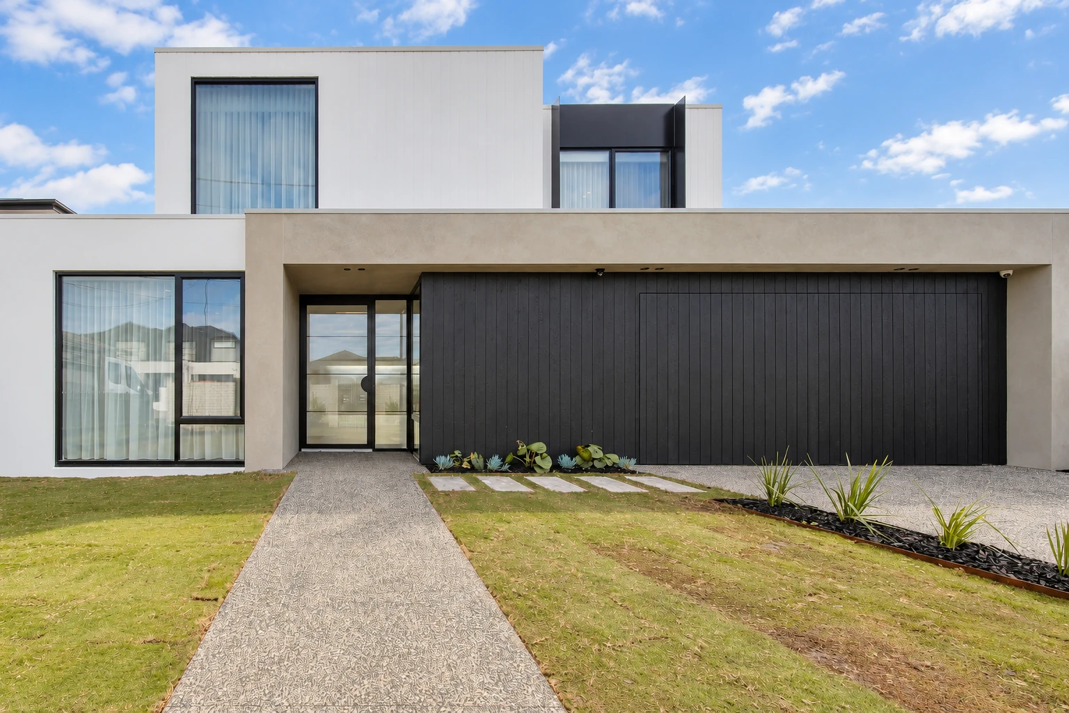 Sculptural white facade and dark timber cladding at Noga Avenue