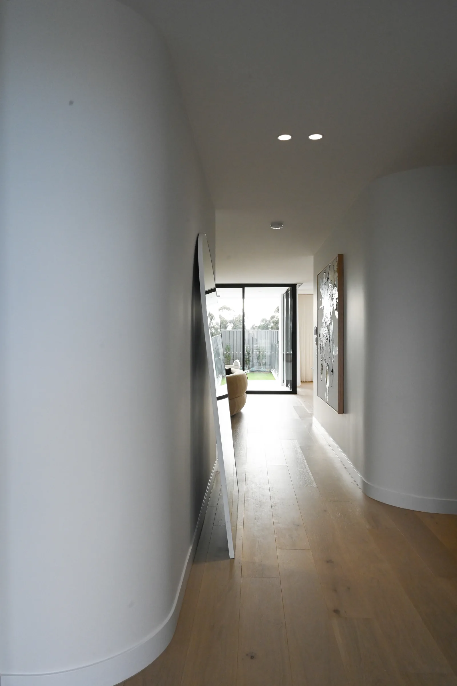 Curved hallway and oak flooring at Noga Avenue