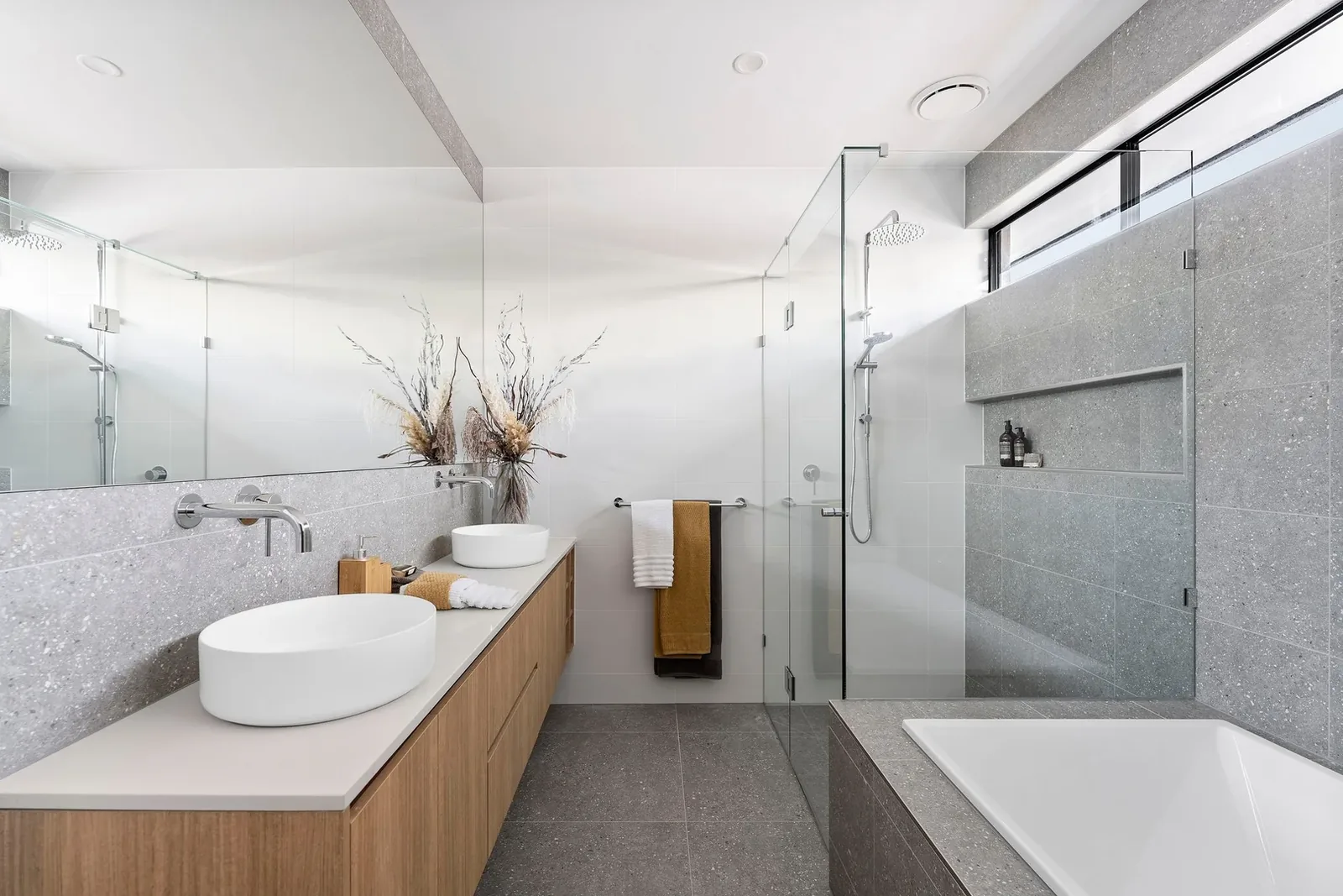Nyah Street bathroom with pale tiles and dark framed fittings