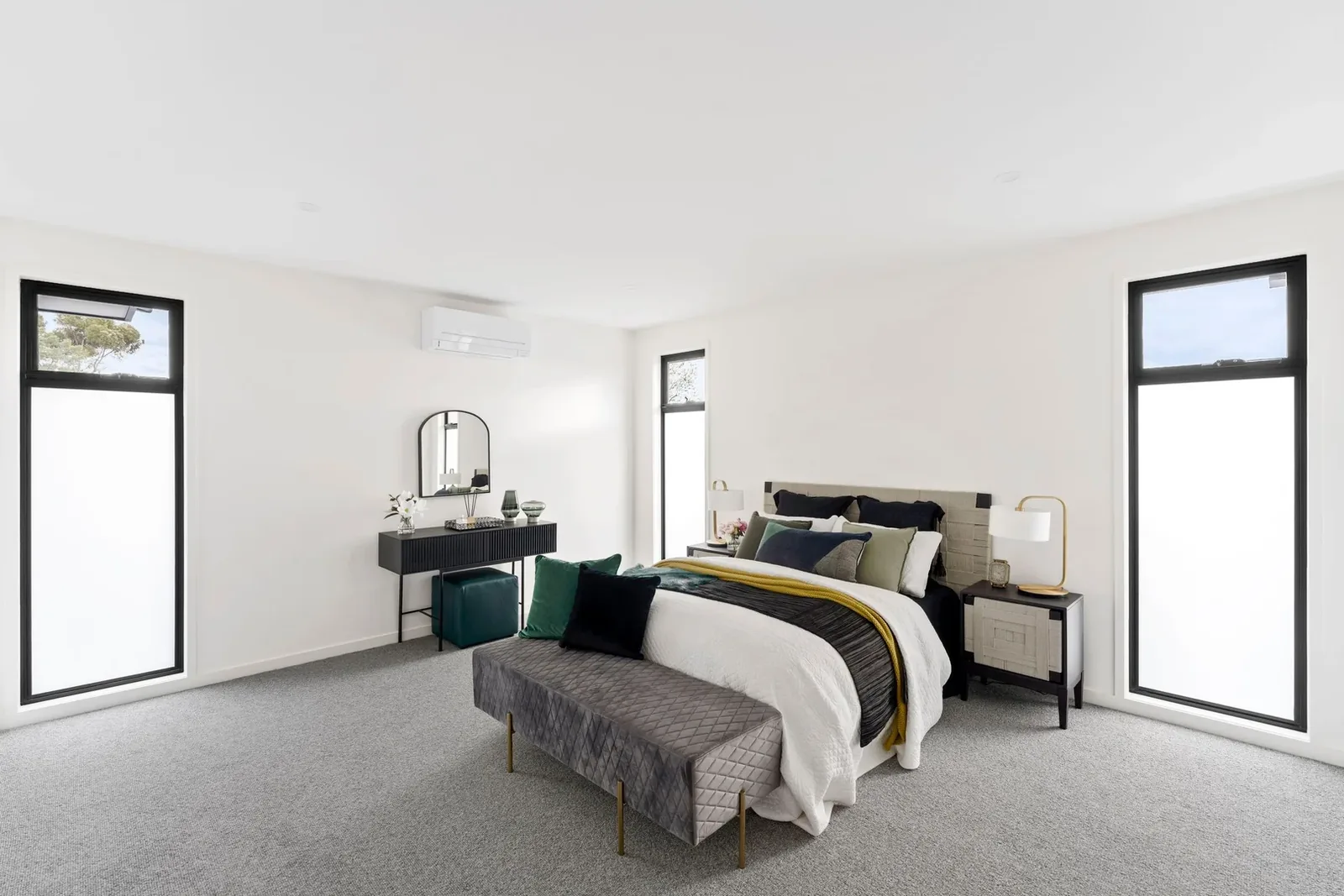 Bedroom at Nyah Street with soft grey carpet and black-framed windows